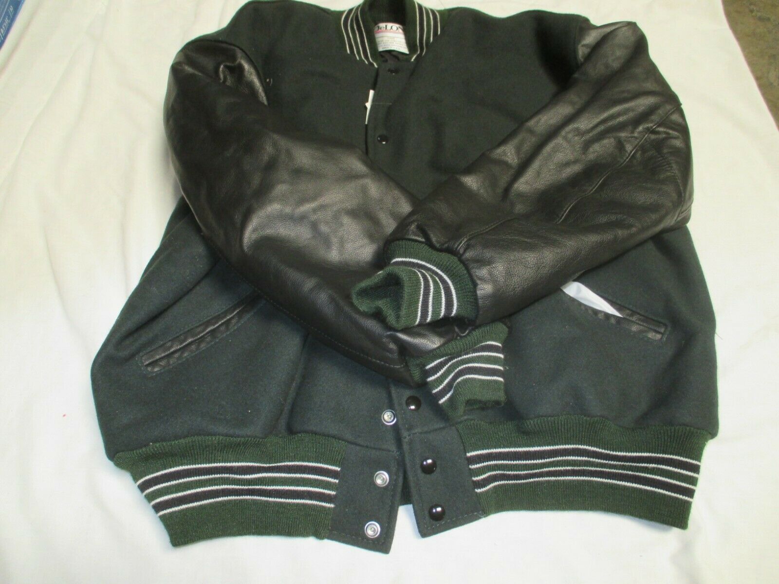 DELONG ADT DK GRN BODY& BLK SLEEVE QLT LINED 2 BLK STRIPES OUTLINE IN WHTJACKET