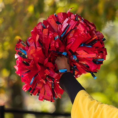 A pom pom being held up by a cheerleader.