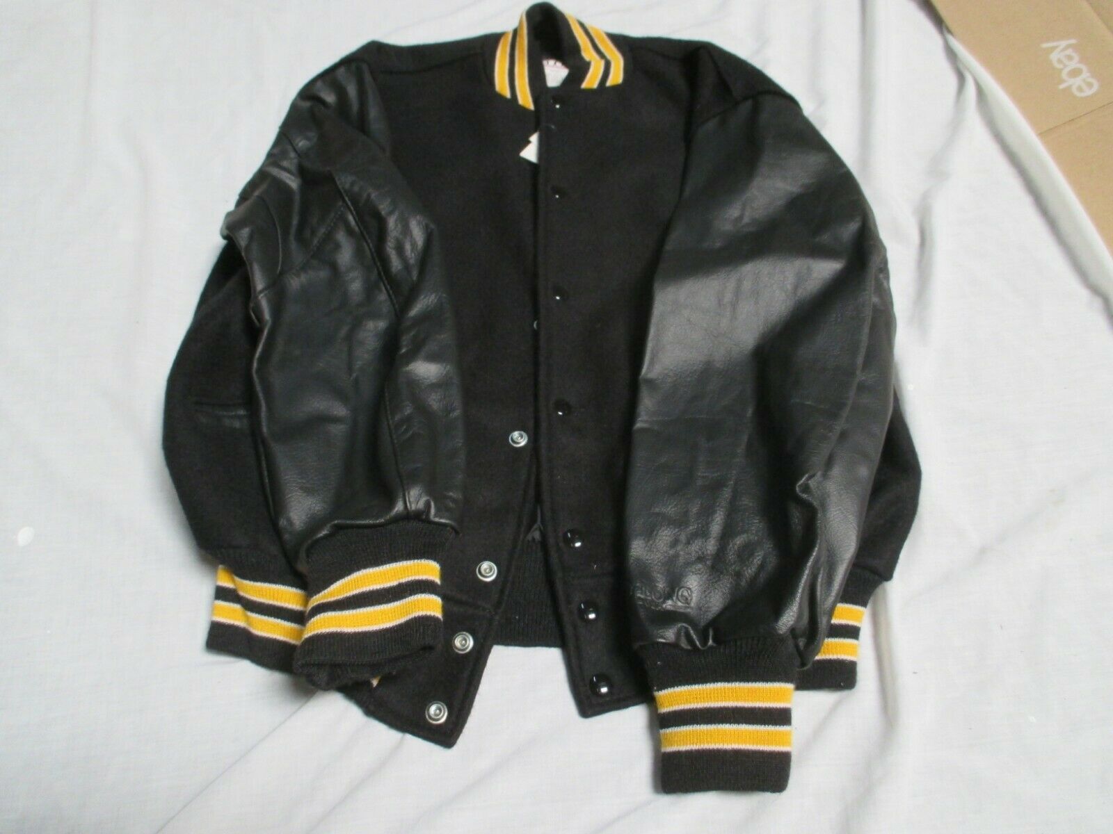DELONG ADULT BLK BODY & SLEEVES 2 GLD  STRIPES OUTLINE IN WHT QUILT LINED JACKET