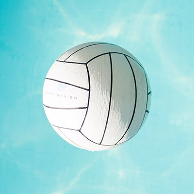 A volleyball floating in the water.